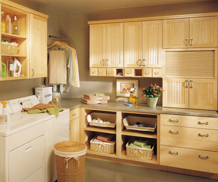 Natural maple cabinets in a laundry room by Kemper Cabinetry