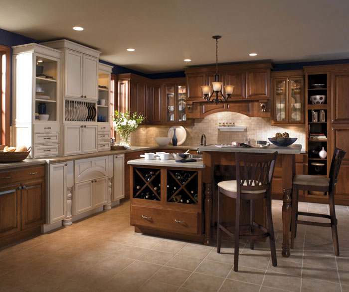 Cherry wood cabinets with a two level kitchen island by Kemper Cabinetry